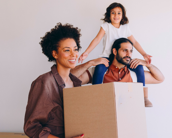 a family happily moving in to a new home