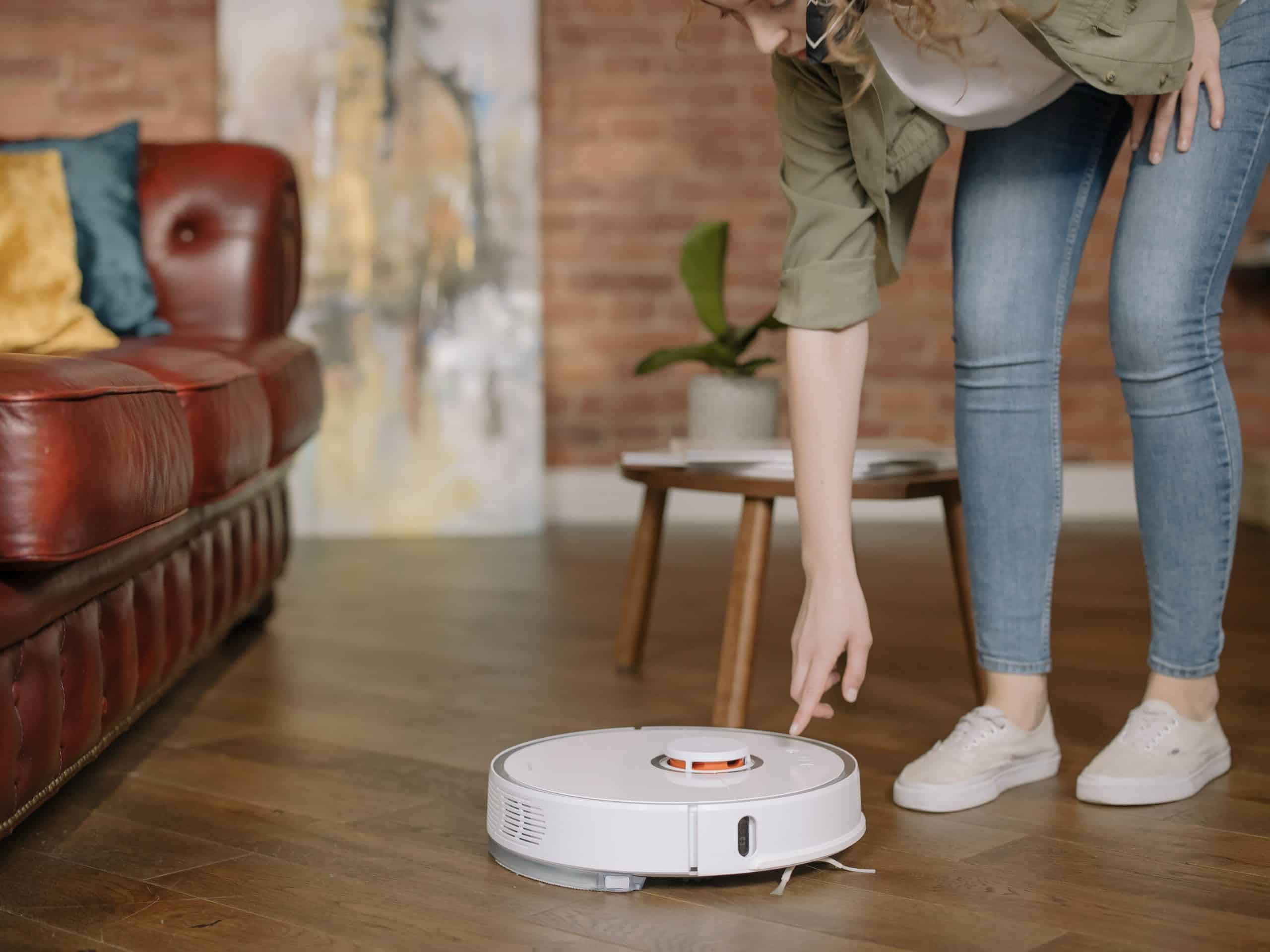 woman using a robot vacuum