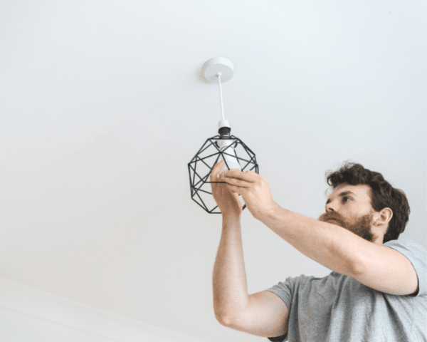 Man replacing the light fixture