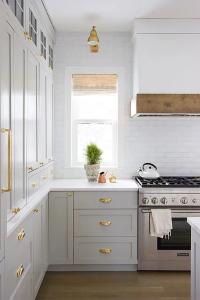 Light gray kitchen with gold accents
