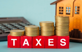 image of a house, money and calculator with the word Taxes in front