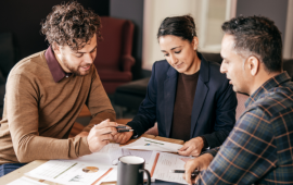 Mortgage Servicer and clients sitting down on a meeting