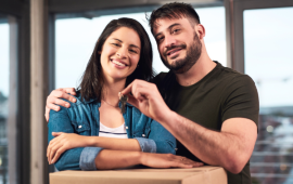 man and woman moving in to their new home