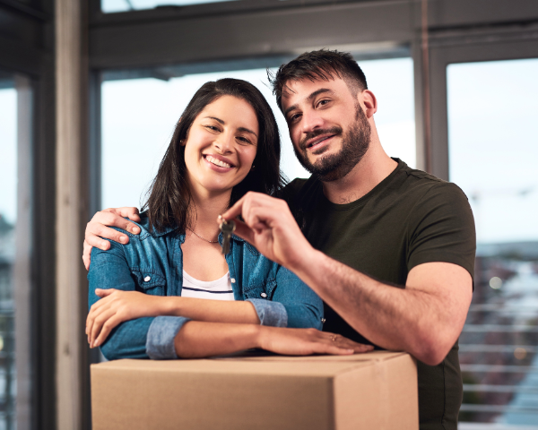 man and woman moving in to their new home