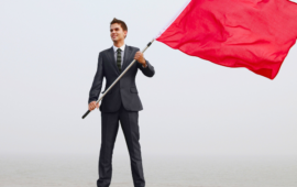 a man raising a red flag