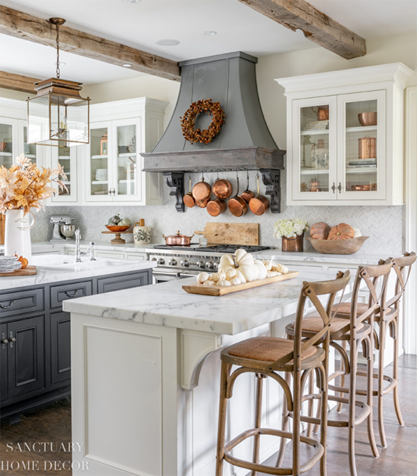 farmhouse style kitchen with gray cabinets and copper pans