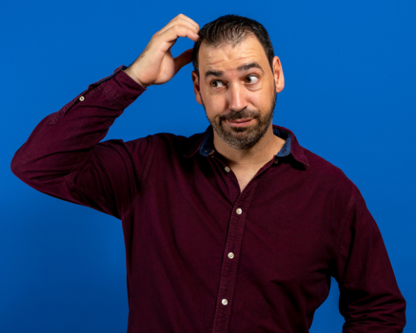 man looking confused and scratching his head