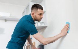 man wiping down the walls