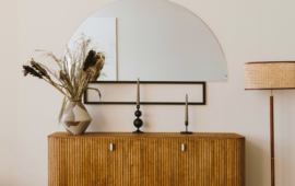 Mahogany console table with a half circle accent mirror above it