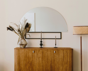 Mahogany console table with a half circle accent mirror above it