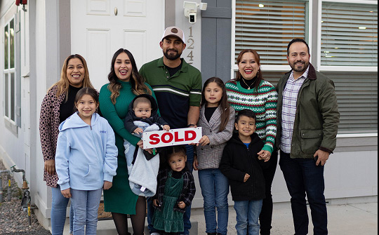 family in front recently sold house