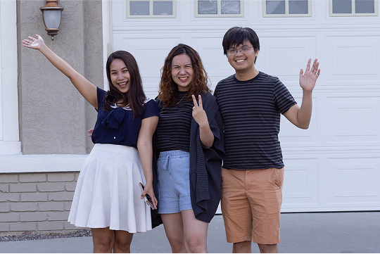 family standing in front of house