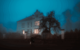 foggy air covering a spooky looking housen at night