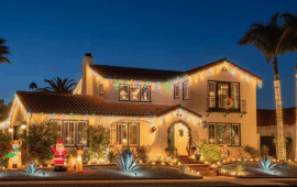 A home in San Diego decorated with lots of Christmas lights at night