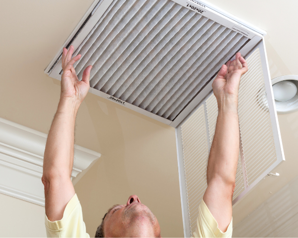 man replacing the air filter