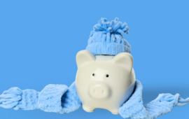 piggy bank wearing a blue cashmere scarf