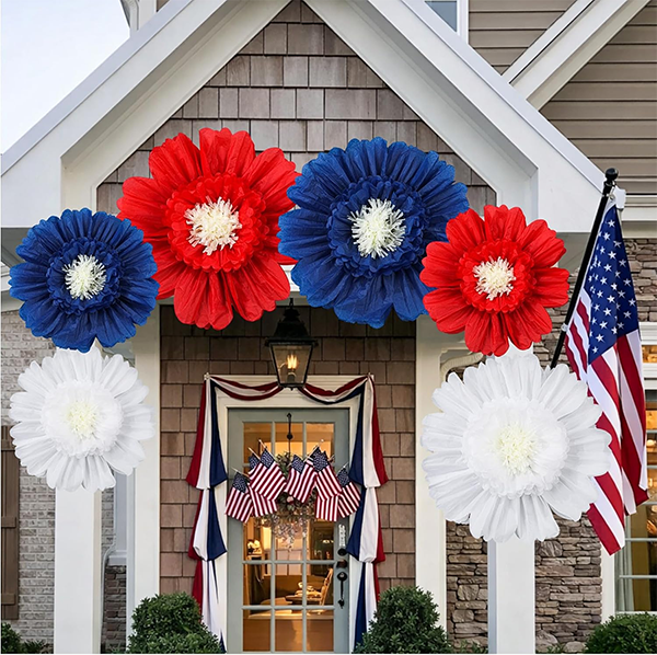 Patriotic floral decorations in red, white, and blue adorn a house entrance. American flags hang above the door, creating a festive atmosphere. Patriotic floral decorations in red, white, and blue adorn a house entrance. American flags hang above the door, creating a festive atmosphere.