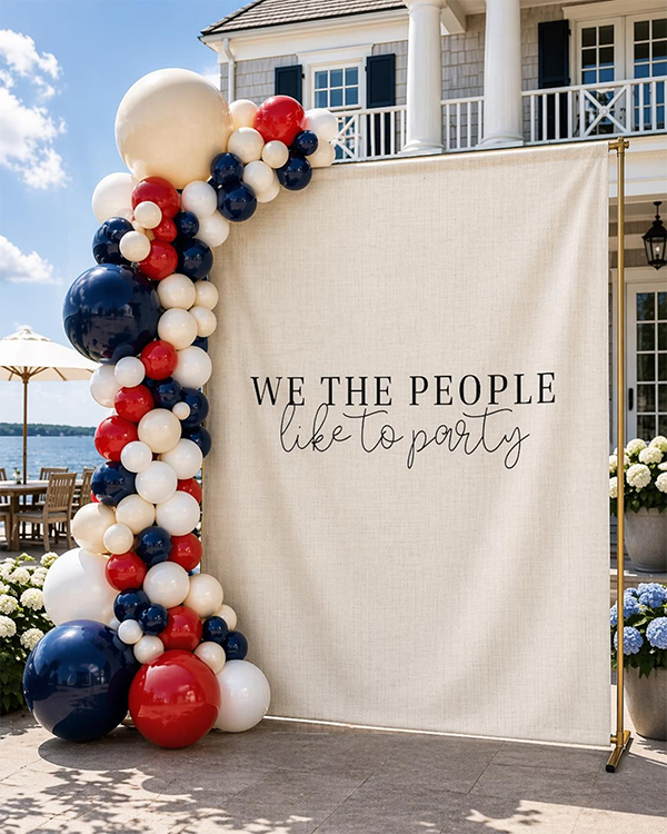 Patriotic party backdrop with red, white, and blue balloons framing a banner that says, We the People like to party. Festive and celebratory vibe. Patriotic party backdrop with red, white, and blue balloons framing a banner that says, We the People like to party. Festive and celebratory vibe.
