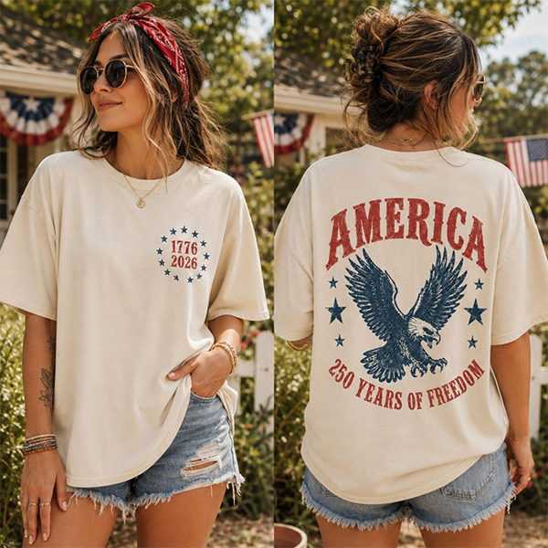 Woman in sunglasses and a red bandana wearing a beige patriotic T-shirt with 1776-2026 and an eagle design. Denim shorts, summer vibe. Woman in sunglasses and a red bandana wearing a beige patriotic T-shirt with 1776-2026 and an eagle design. Denim shorts, summer vibe.